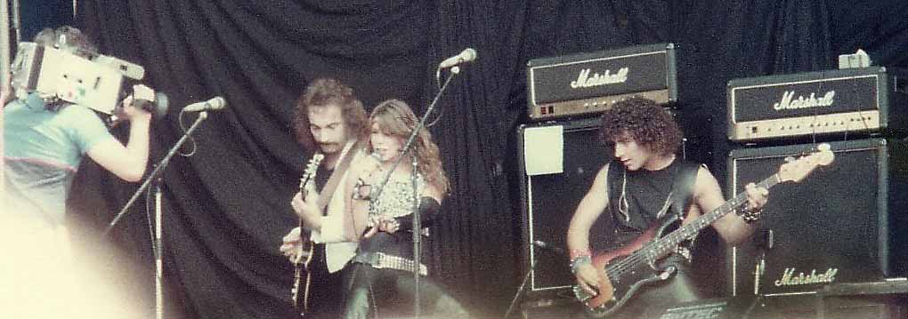 Lee Aaron,John Albani and Jack Meli on stage at the Reading Festival 1983. Photo by Don Murphy ©